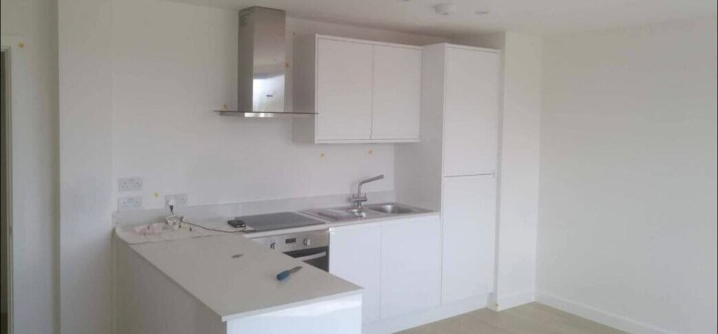 Kitchen installation work in progress showing cabinetry, fittings, and ongoing snagging checks.