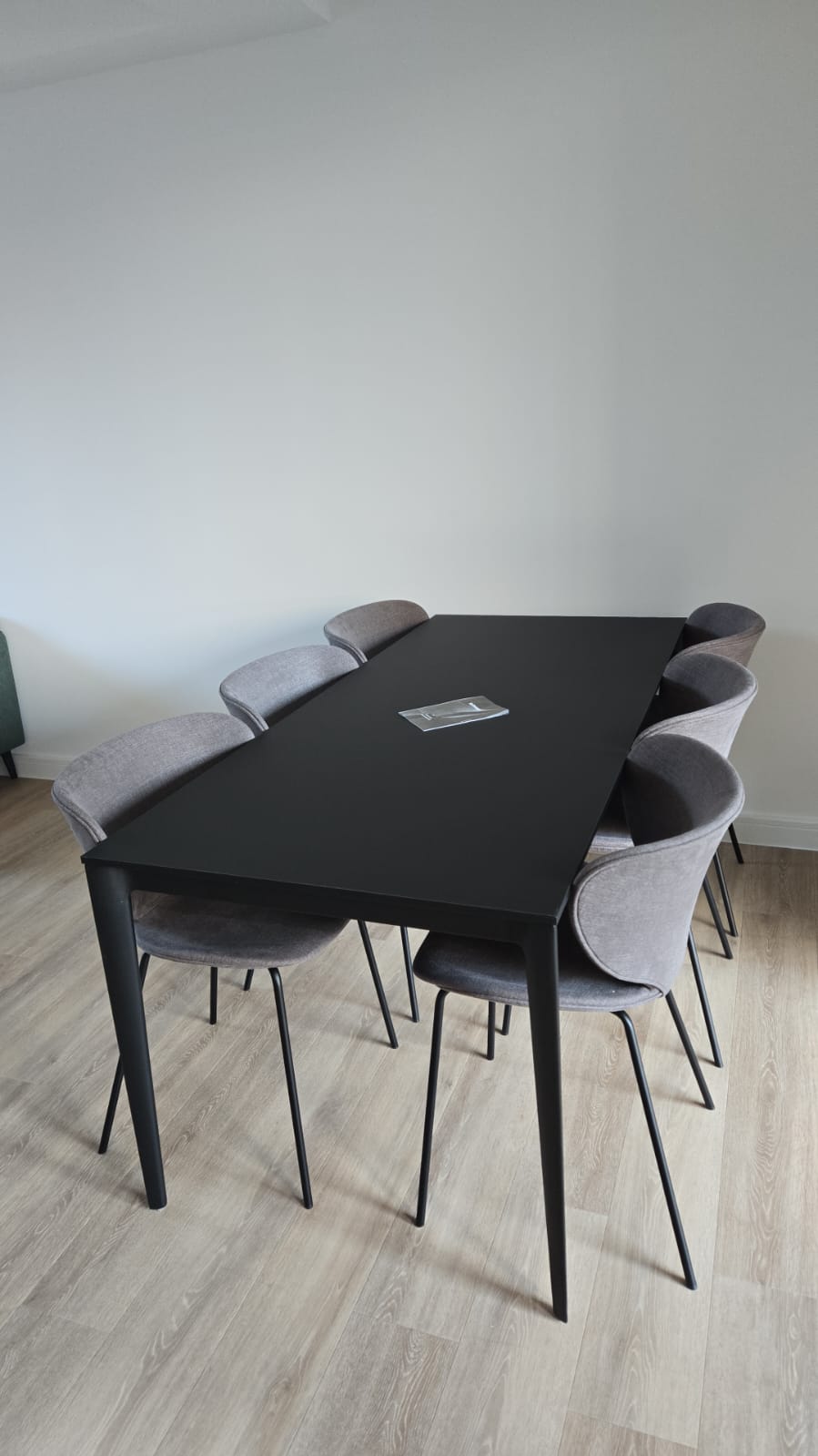 Dining table and chairs assembled inside a newly completed apartment during a large-scale fit-out programme.